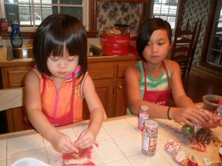 Kasen and Karis baking cookies for Santa